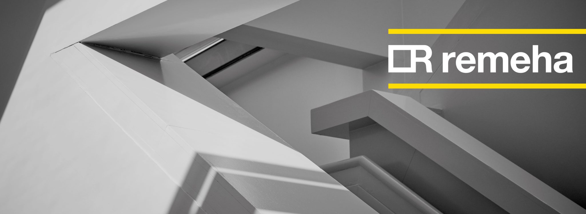 Remeha rebrand case study hero image. Abstract, greyscale architectural shot with new, yellow and white logo overlaid