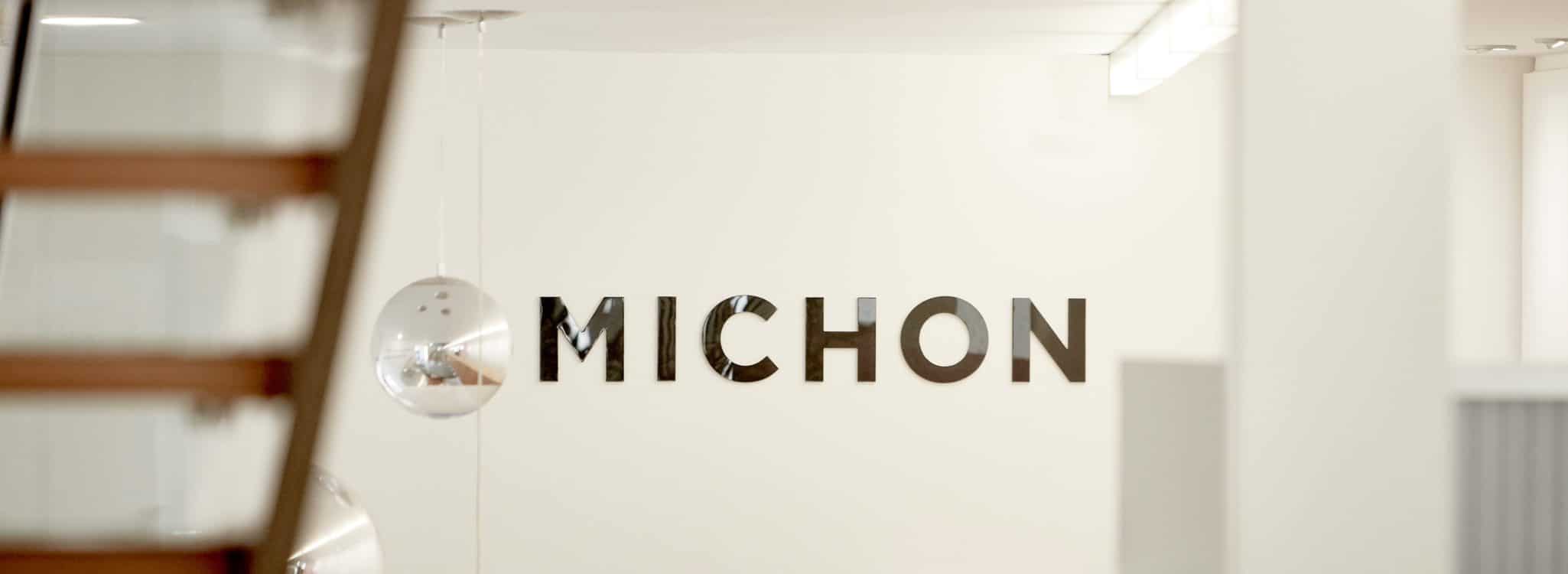 Michon Creative Brand Agency Interior Front Entrance with Michon chrome Michon logo on white wall