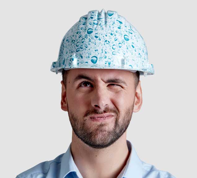 Head and shoulders phto of Hanson Employee Ryan wearing a hard hat with a photo of water drops on it