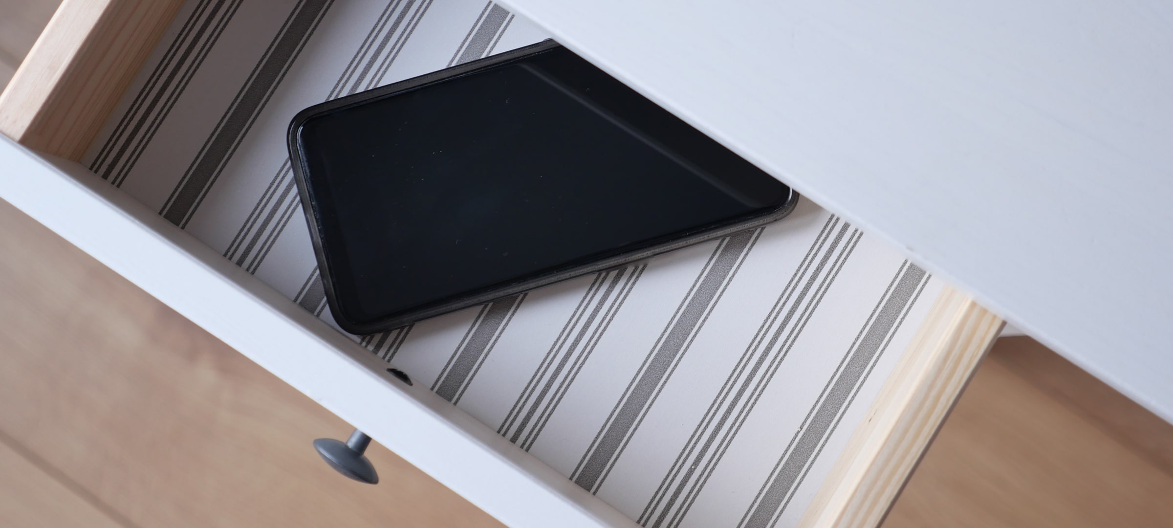 An image of a phone shut away in a drawer